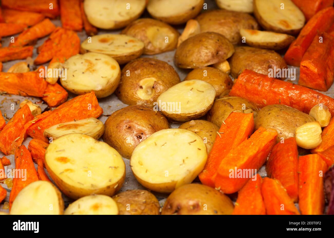 Winter comfort food roasted root vegetables on a oven tray covered