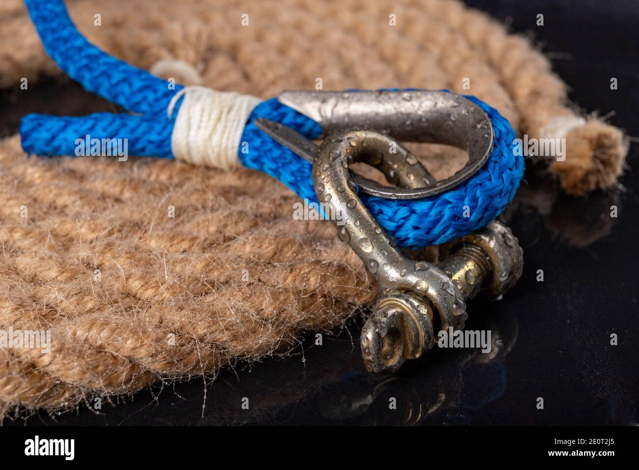 Wet shackle and rope. Accessories for sea wolves on the table. Dark  background Stock Photo - Alamy