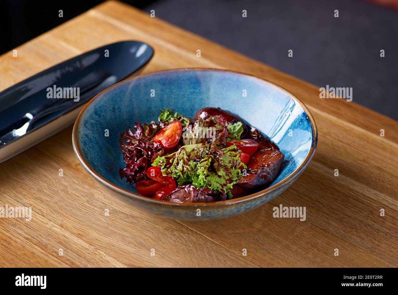 Rabbit liver salad on the table, serving in a restaurant, menu food
