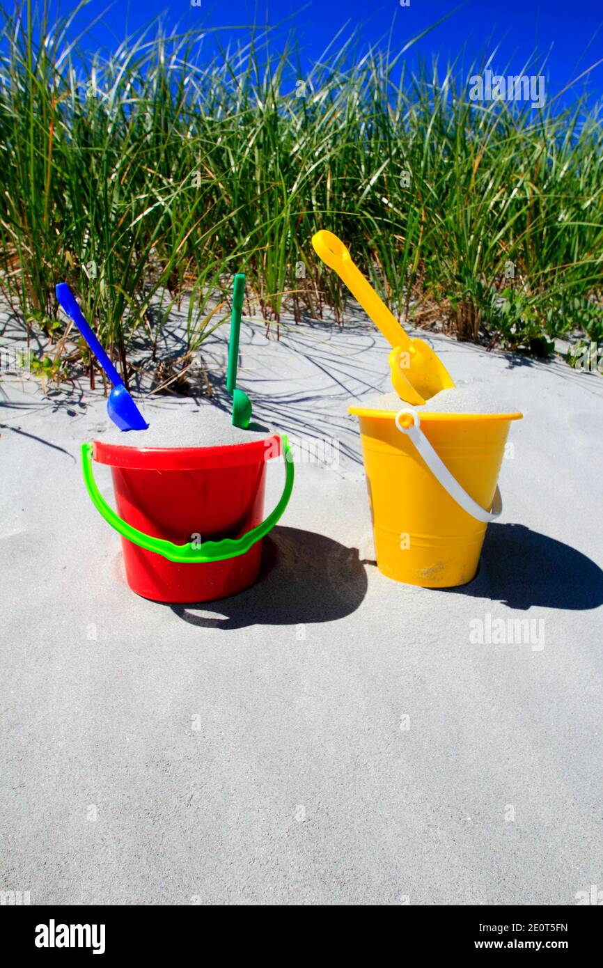 two child's beach buckets filled with sand on a beach Stock Photo Alamy
