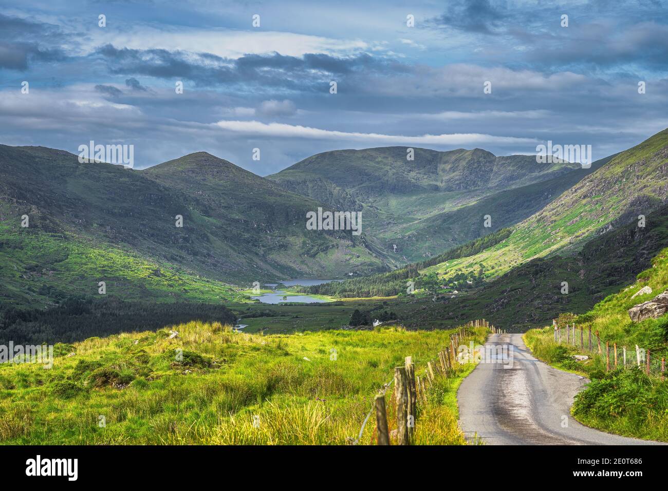 Long Country Road Leading To Majestic Black Valley With Lake And Mountain Range Covered In Sunlight And Shadows From Clouds County Kerry Ireland Stock Photo Alamy