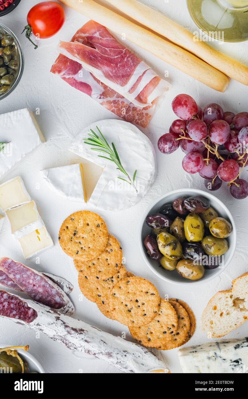 Antipasti platter with fresh cheese, bread and olive, on white