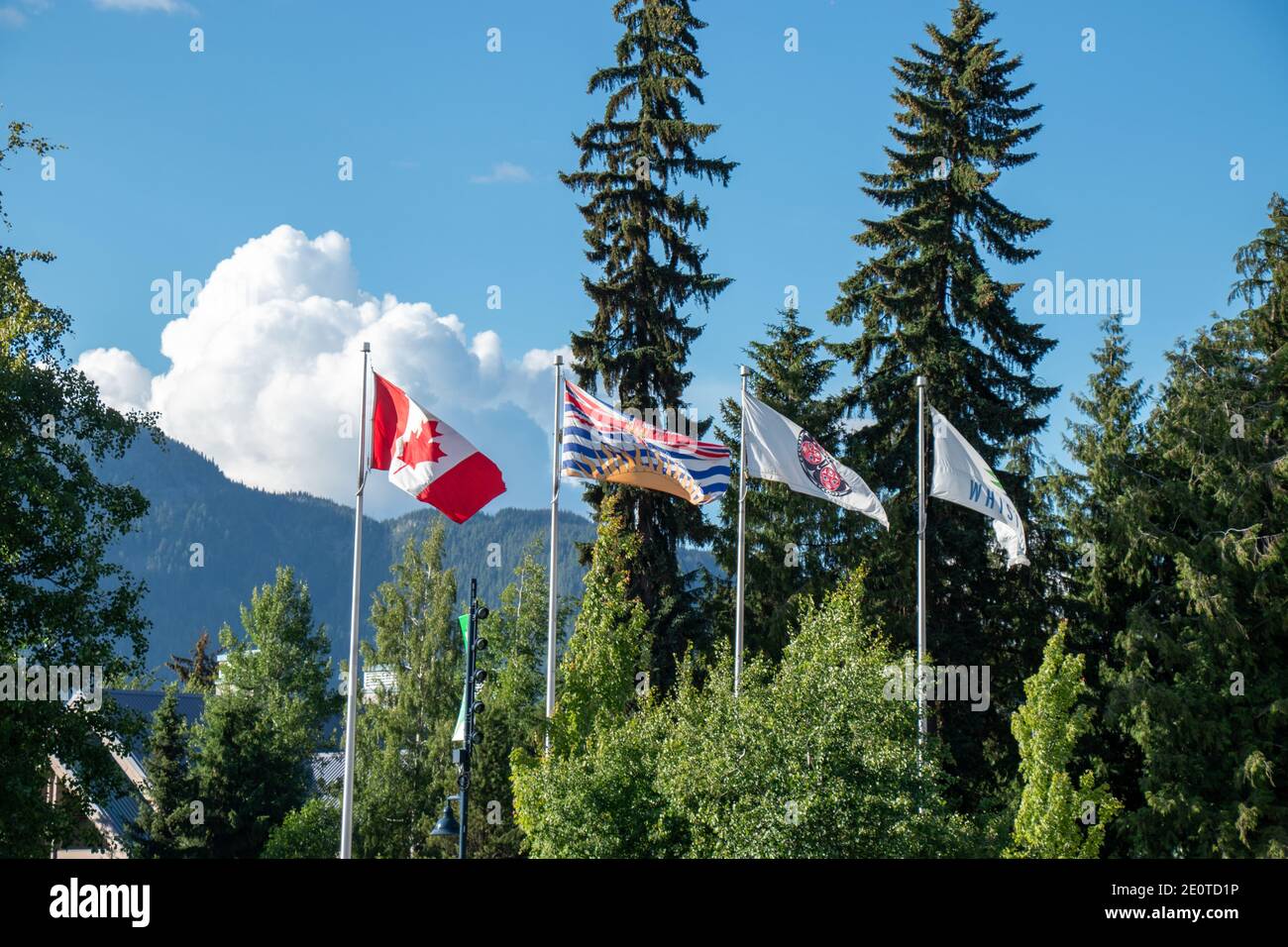 Whistler, Canada - July 5,2020: View of poles with waving flags in the Whistler Village Stock Photo