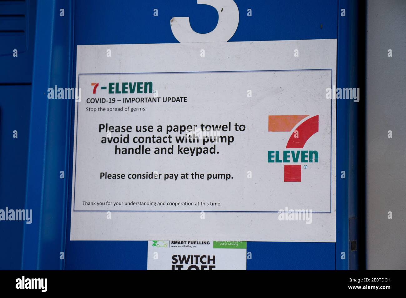 Vancouver, Canada - July 13,2020: Covid-19 update sign at  Esso Gas Station. Please avoid contact with pump handle and keypad. Stock Photo