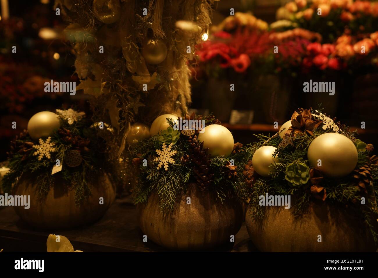 Illuminated showcase with flower bouquets, baubles and Christmas