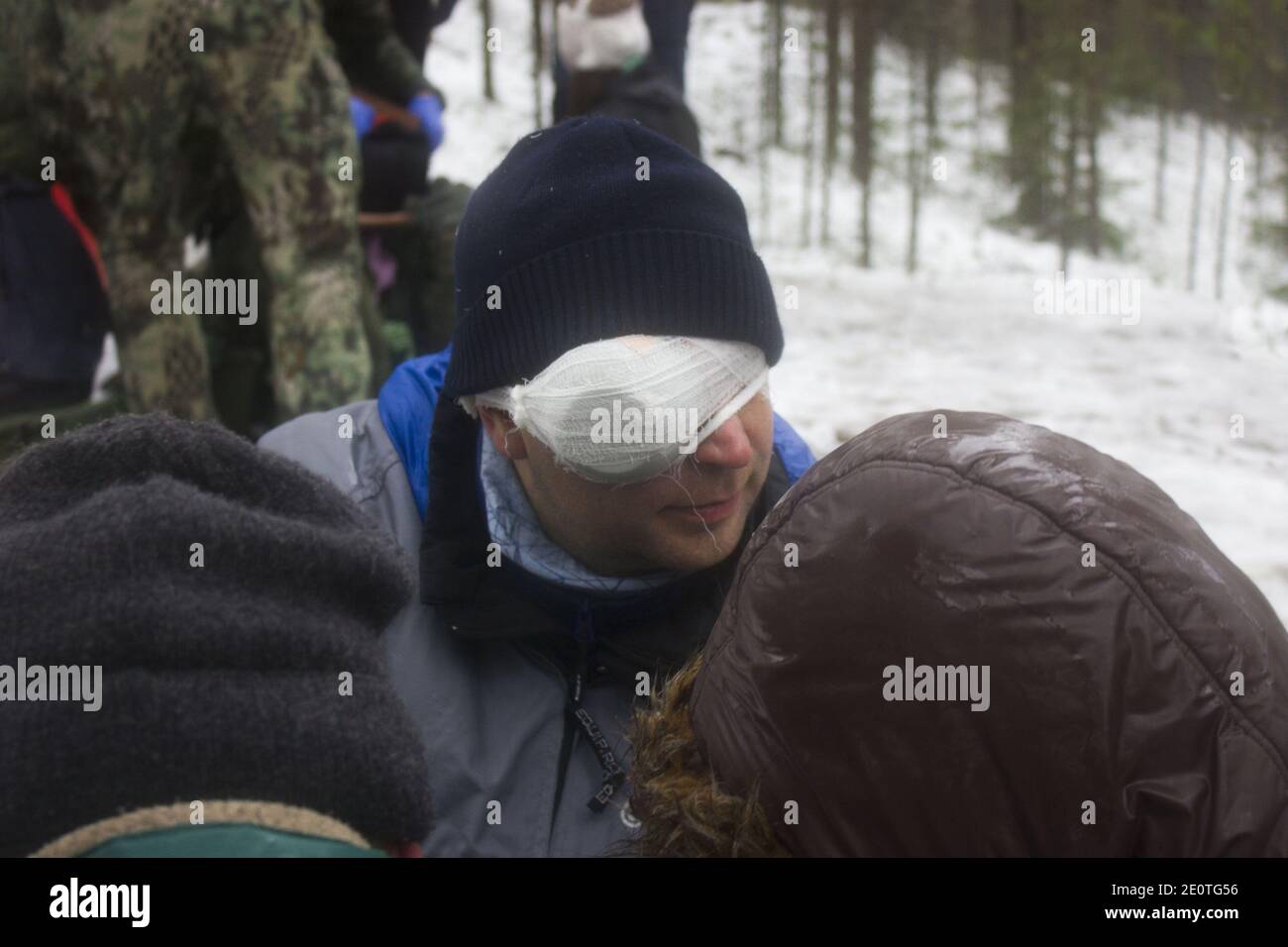 Training in first aid for eye injury. Reportage from a place in the winter forest where the
