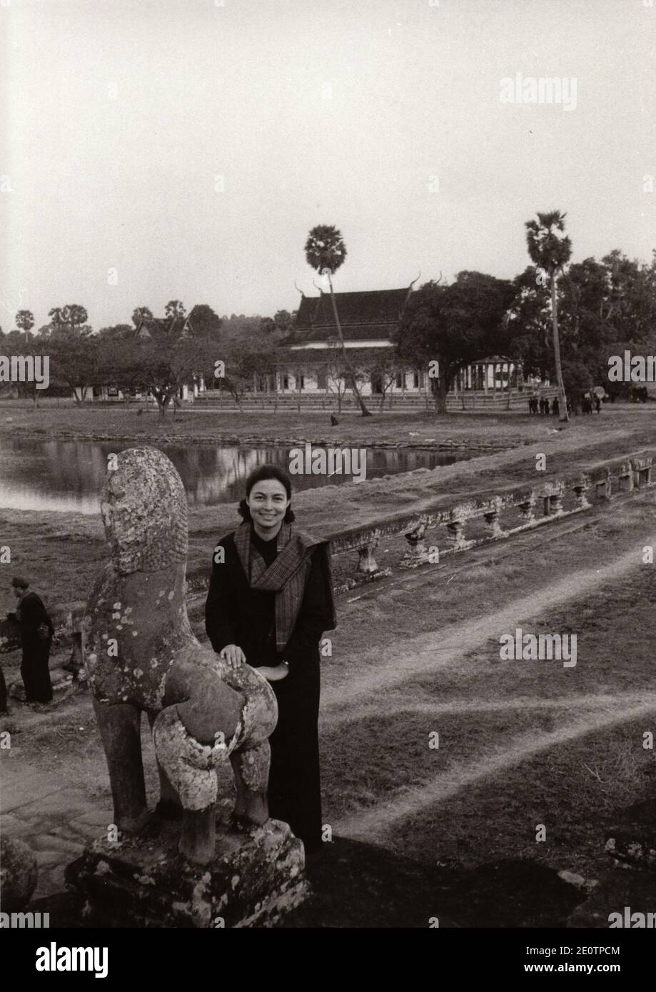 Princess Monique. wife of Prince Norodom Sihanouk, the President of Royal Government of National Union of Cambodia (GRUNC), poses for her husband in front of Angkor Wat during a visit in the 'liberated zones ' of Cambodia on March 1973. Sihanouk, deposed on March 1970 by Lt.Gen. Lon Nol, was joined in an alliance by an underground Marxist insurgency group, the Khmers Rouges, led officially by Khieu Samphan and Ieng Sary. In reality Saloth Sar (Pol Pot) was the real 'number 1' of the Revolutionary movement. Today: Queen Mother Norodom Monineath Sihanouk was born on June 18, 1936, in Saigon, Vie Stock Photo