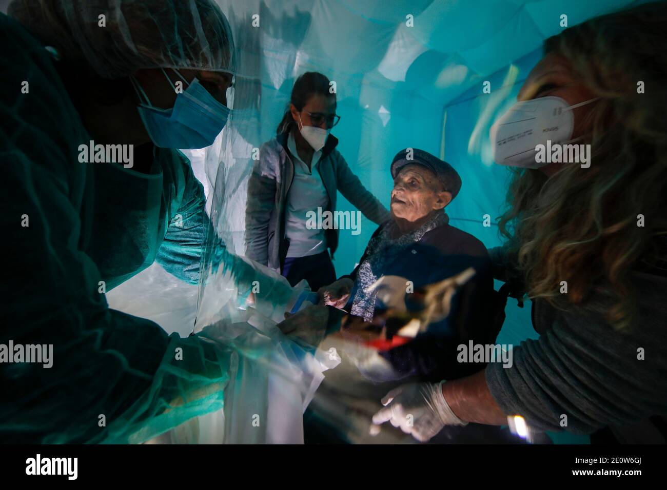 Serino, Italy. 02nd Jan, 2021. Family members hug each other inside a hug room set up at the Santa Lucia Home in Serino, Campania region, southern Italy. The hug room in Campania was an initiative of to allow, after long months of isolation due to the restrictive anti-COVID-19 measures, the elderly guests of the social welfare structures to meet their families closely and be able to hug and hold each other hands. Credit: Independent Photo Agency/Alamy Live News Stock Photo