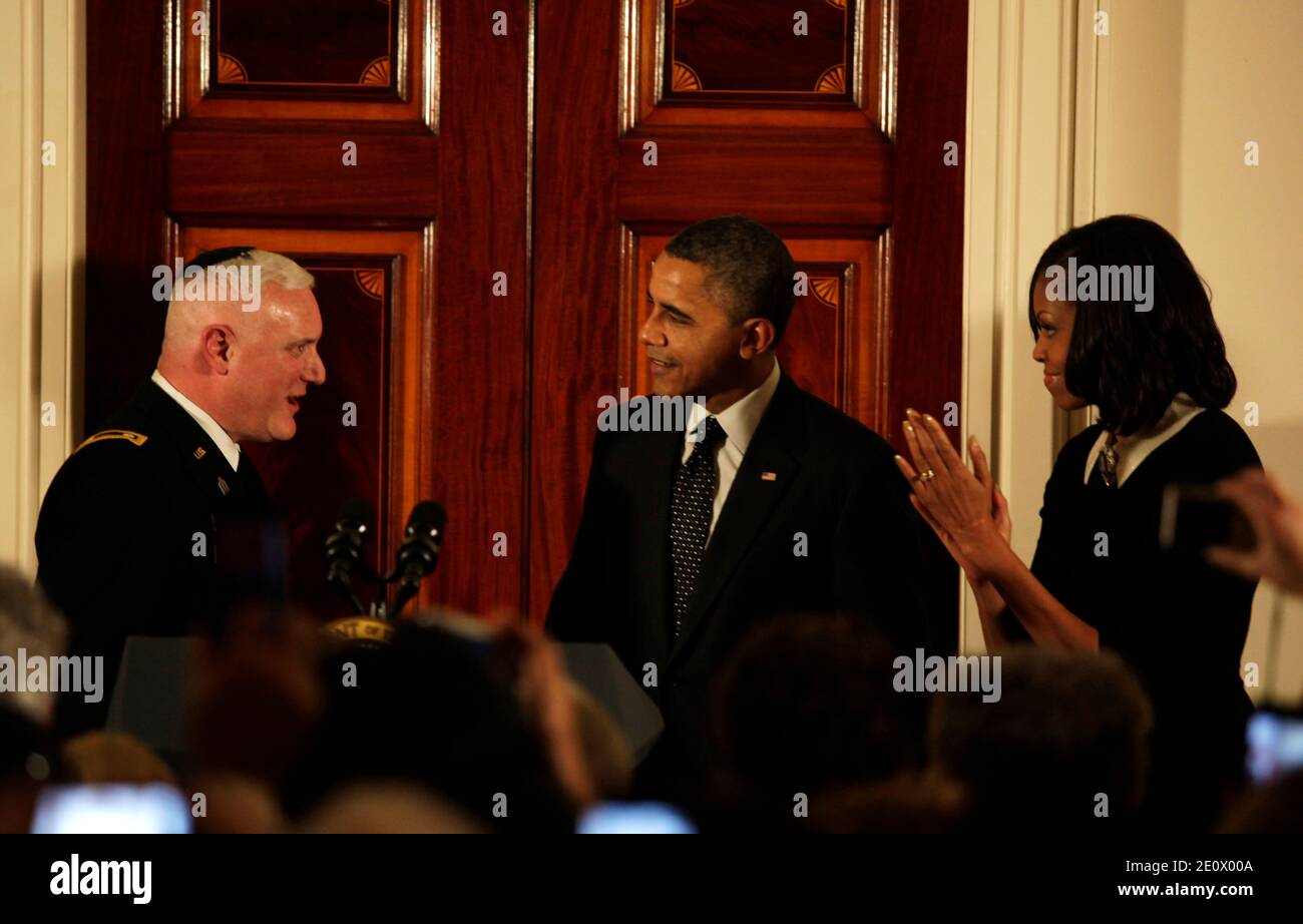 Rabbi Larry Bazer lights the Menorah while U.S. President Barack Obama ...