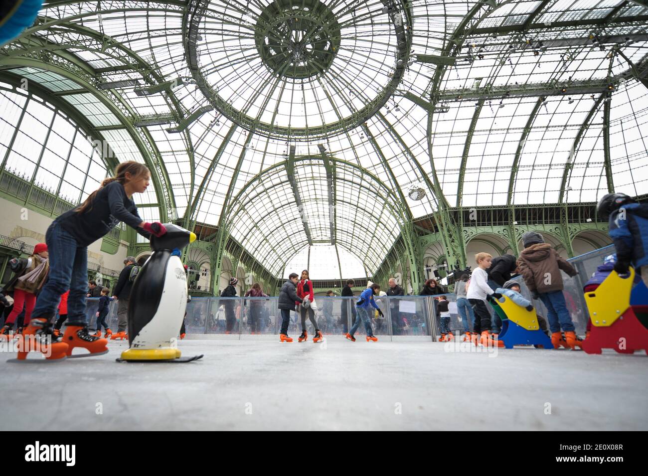 Visitors ice-skate on a giant rink hosted in the glass-roofed central hall of the Grand Palais, in Paris, France, on December 12, 2012. The rink who is the largest rink ever created in France is 1,800 square meters large and can receive 1000 people at the same time. Photo by Christophe Guibbaud/ABACAPRESS.COM. Stock Photo