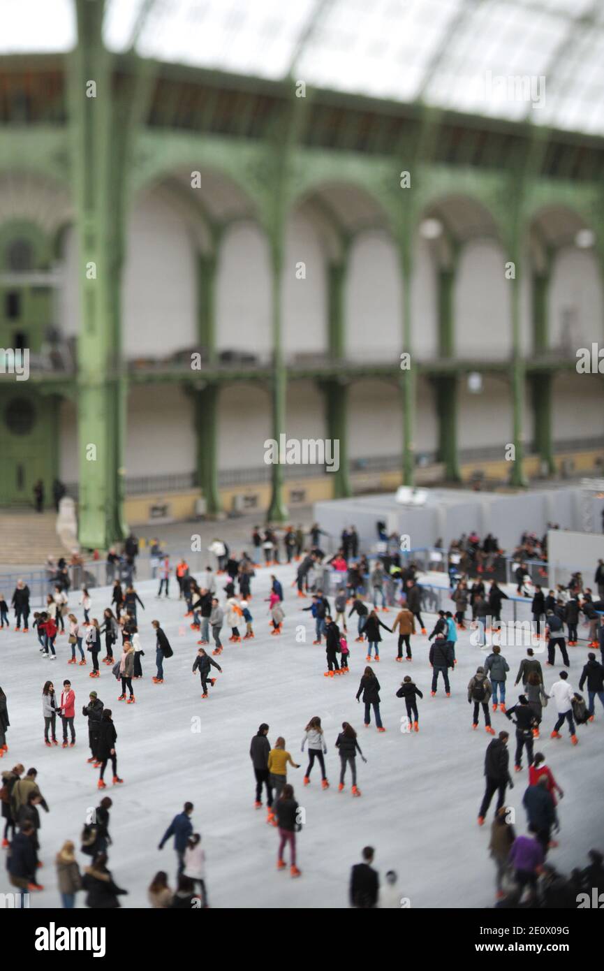 Visitors ice-skate on a giant rink hosted in the glass-roofed central hall of the Grand Palais, in Paris, France, on December 12, 2012. The rink who is the largest rink ever created in France is 1,800 square meters large and can receive 1000 people at the same time. Photo by Christophe Guibbaud/ABACAPRESS.COM. Stock Photo