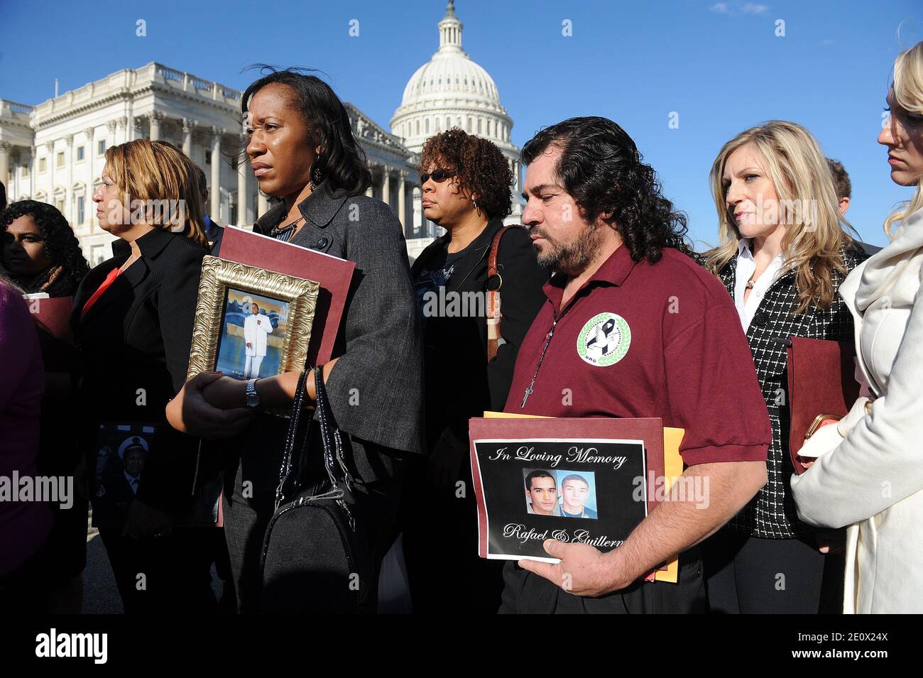Survivors and family members of victims of gun violence including Pam Bodley (L), holding a picture of her son Tyrell and Jose Guzman (R) holding a picture of his son Guillermo, listen during a news conference held at the House Triangle on Capitol Hill in Washington, DC, USA on December 18, 2012. Photo by Olivier Douliery/ABACAPRESS.COM Stock Photo