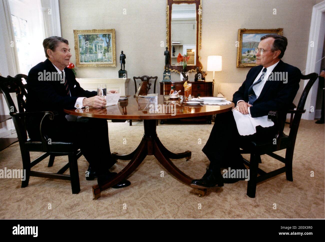 Washington, D.C. - April 27, 1988 -- United States President Ronald Reagan and Vice President George H.W. Bush meet for their weekly lunch in the Oval Office Study at the White House in Washington, DC on April 27, 1988. Photo by White House/CNP/ABACAPRESS.COM Stock Photo