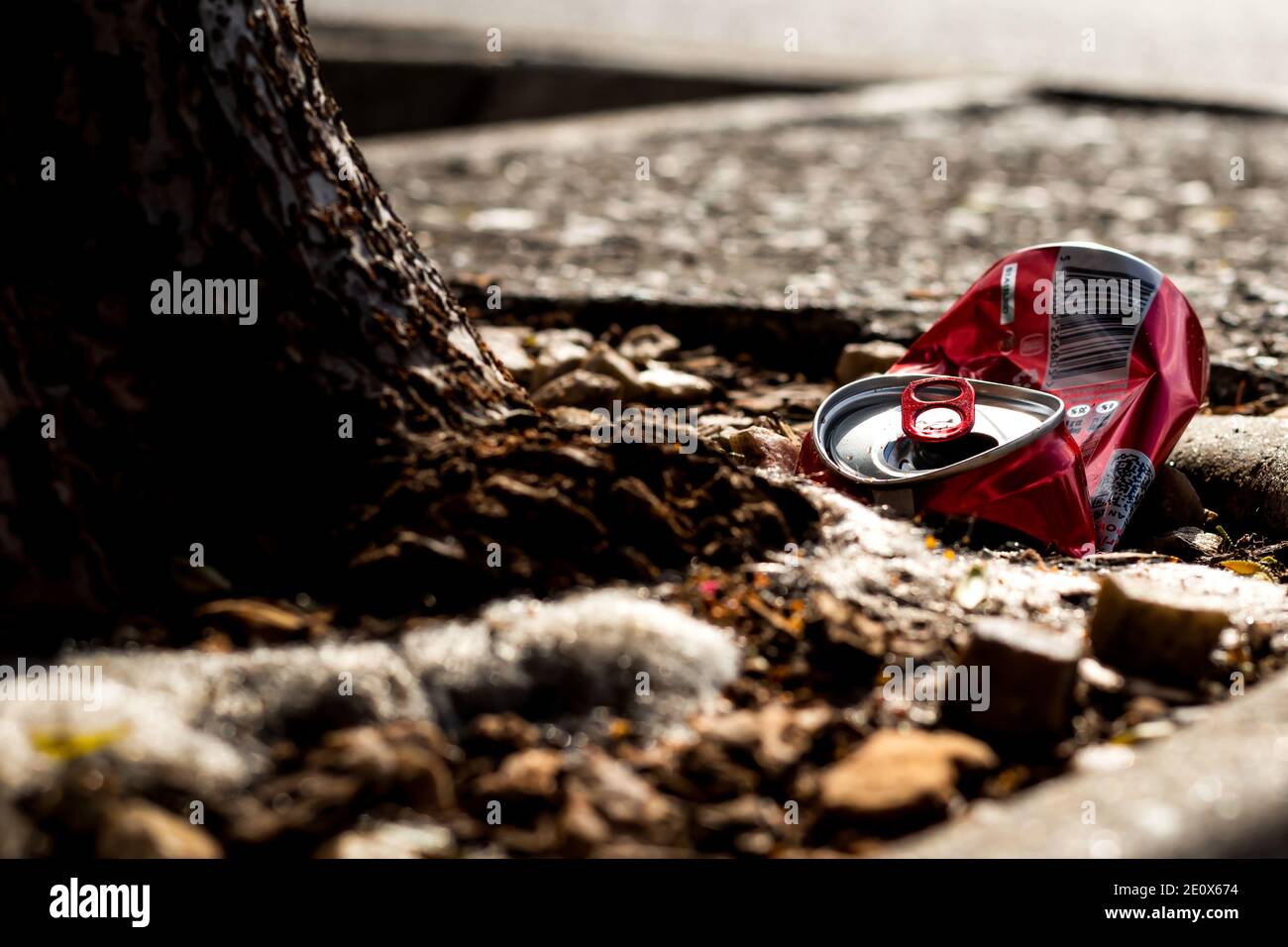Red crushed soda can trown away Stock Photo - Alamy