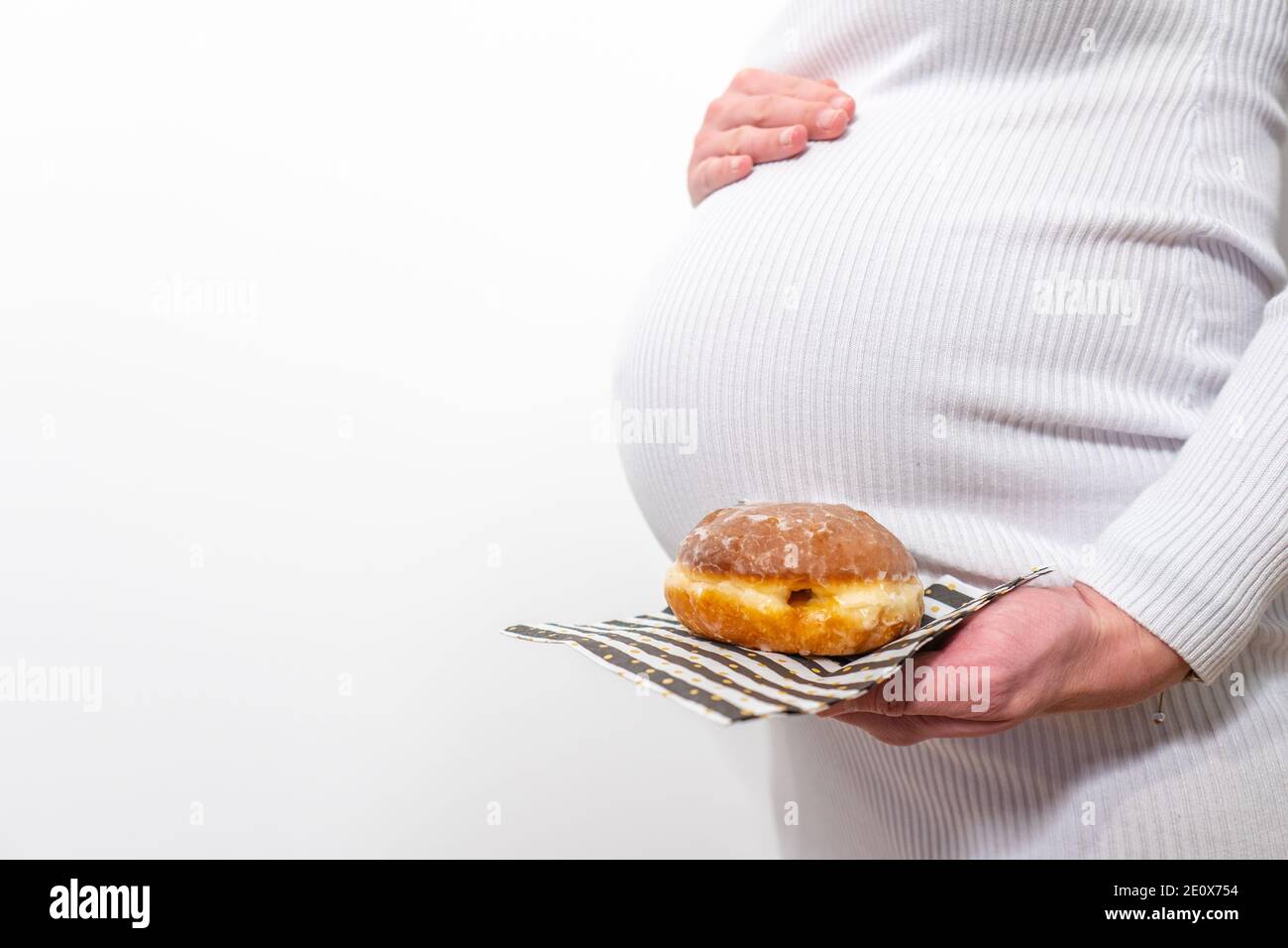 Pregnancy and unhealthy eating concept pregnant woman holds a plate