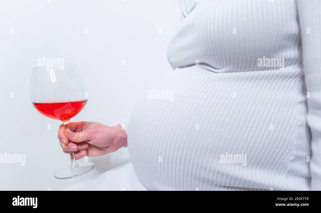 No alcohol during pregnancy. Young pregnant woman refuses to drink wine