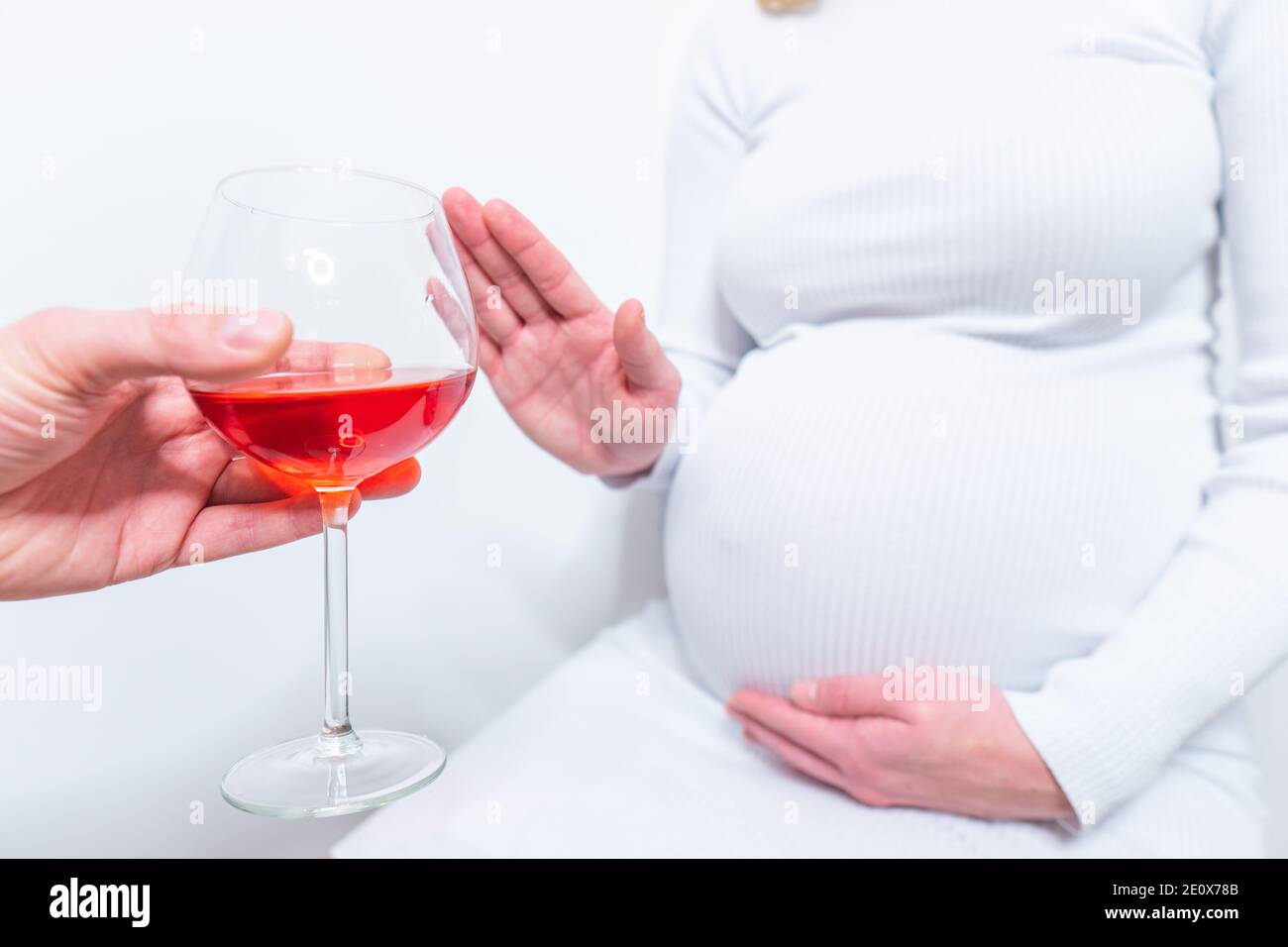 No alcohol during pregnancy. Young pregnant woman refuses to drink wine