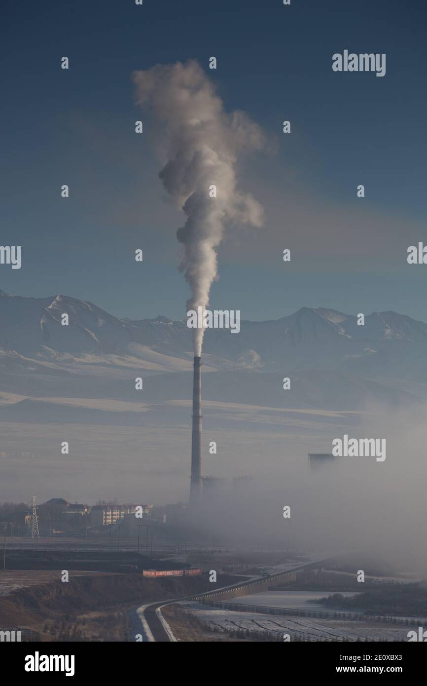 Smoke pouring from a chimney in Qinghai Province, China Stock Photo