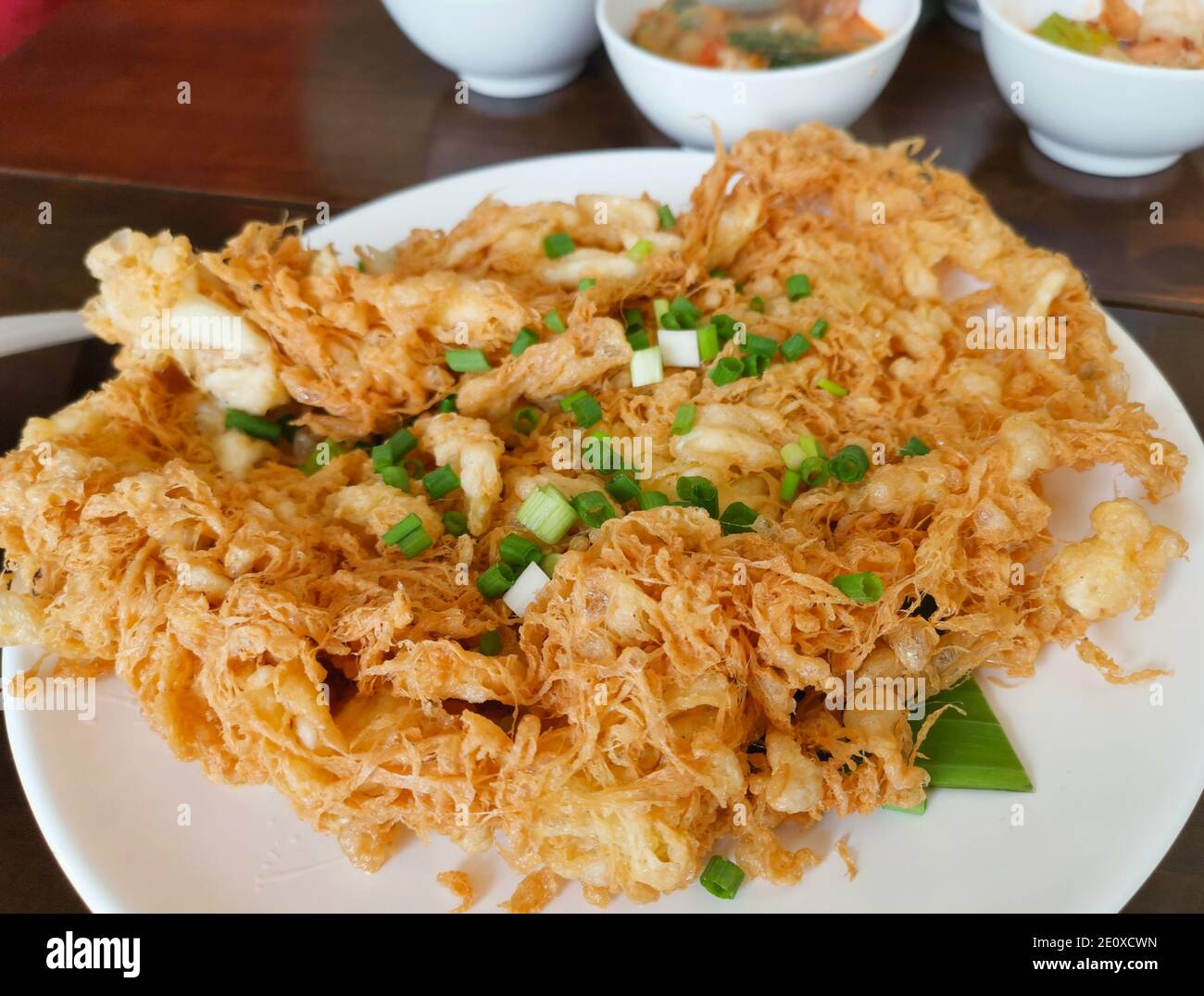 Crispy Omelette Sprinkle with green onion leaves. Thai food Stock Photo