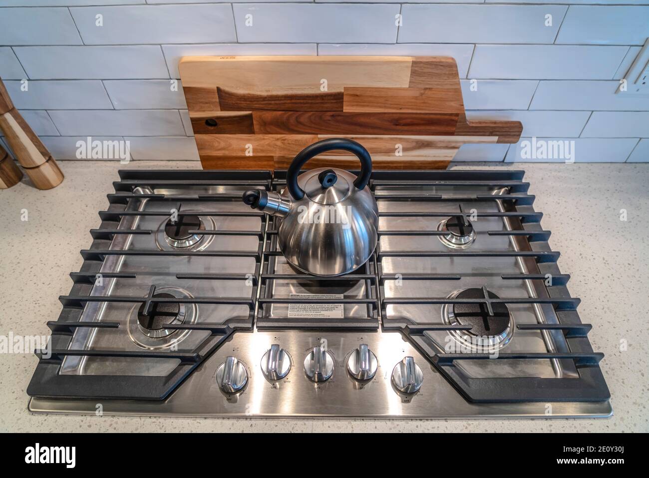 Kettle over burners and grate of a cooktop built into the kitchen