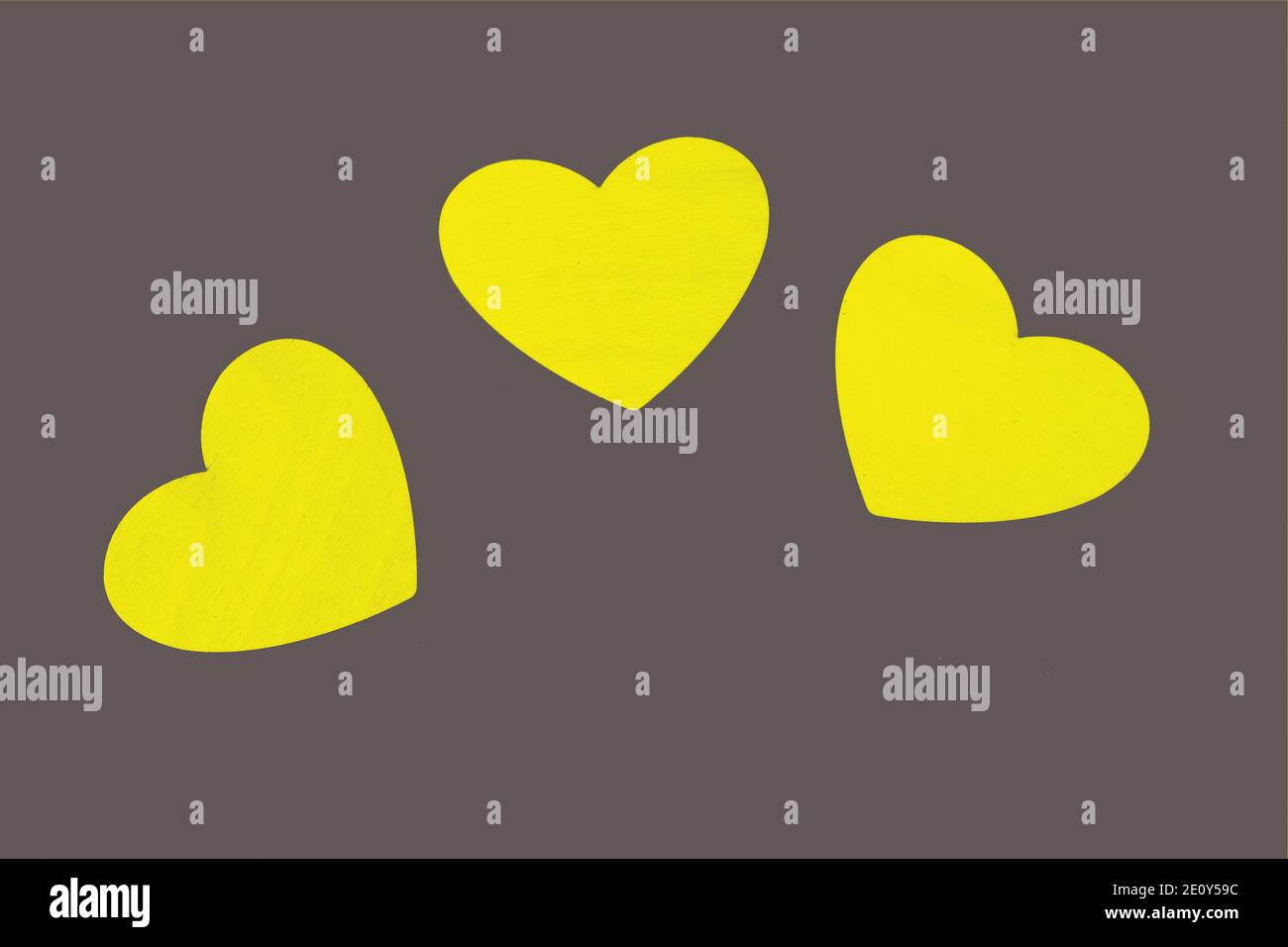 3 yellow hearts on a gray background. Valentine's Day. Illuminating and Ultimate Gray background. pattern in trendy new colors 2020 Stock Photo