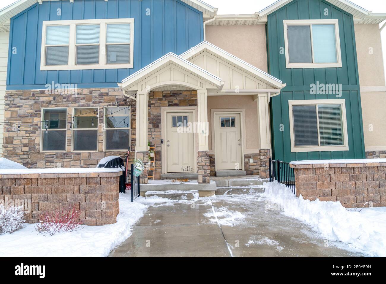 Front view of apartment homes with gable roofs over white glass paned