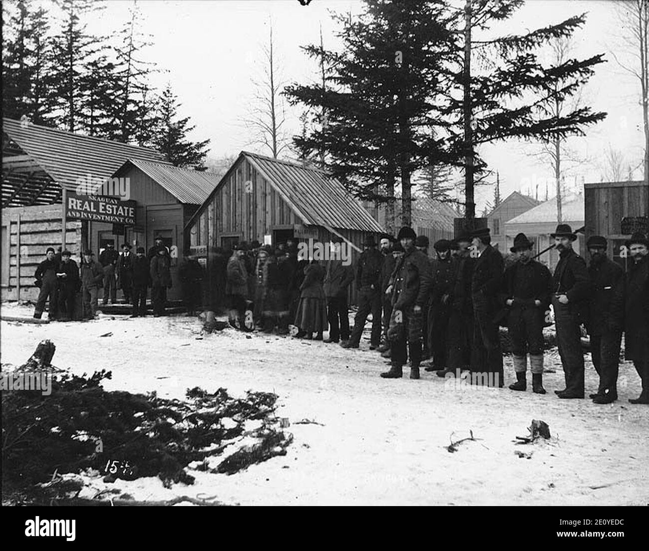 Line of men and women waiting to receive mail at the post office, Skagway, Alaska, ca 1899 Stock Photo