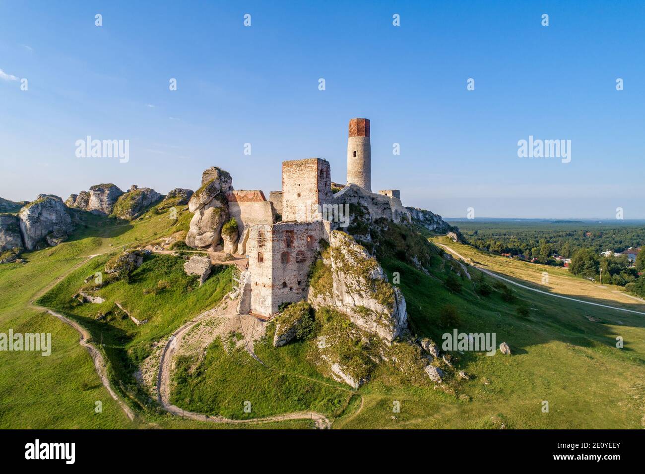 Olsztyn, Silesia, Poland. Ruins of medieval royal castle on the limestone rocks in Polish Jurassic Highland near Czestochowa. Aerial view in sunrise l Stock Photo