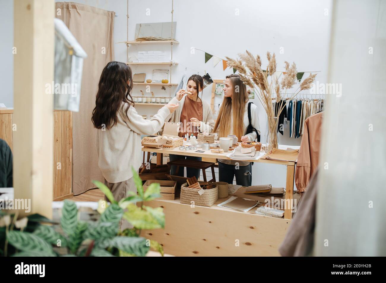 Longshot of young women in ecological shop choosing between cosmetic products Stock Photo