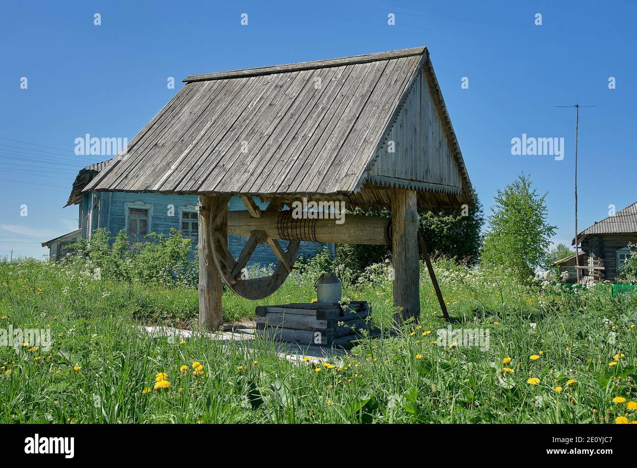 old wooden village well with wheel Stock Photo