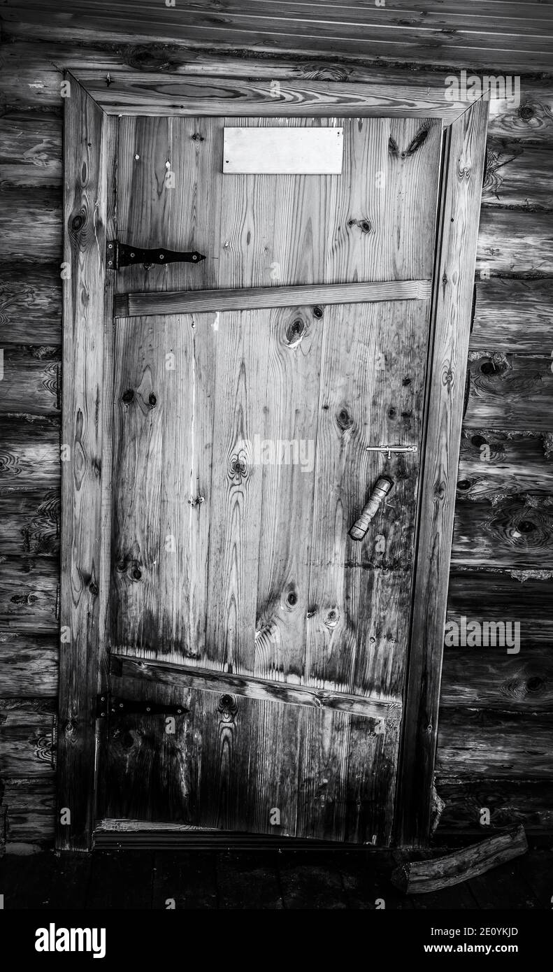 The old rickety door of a wooden log house. Black and white photo Stock ...
