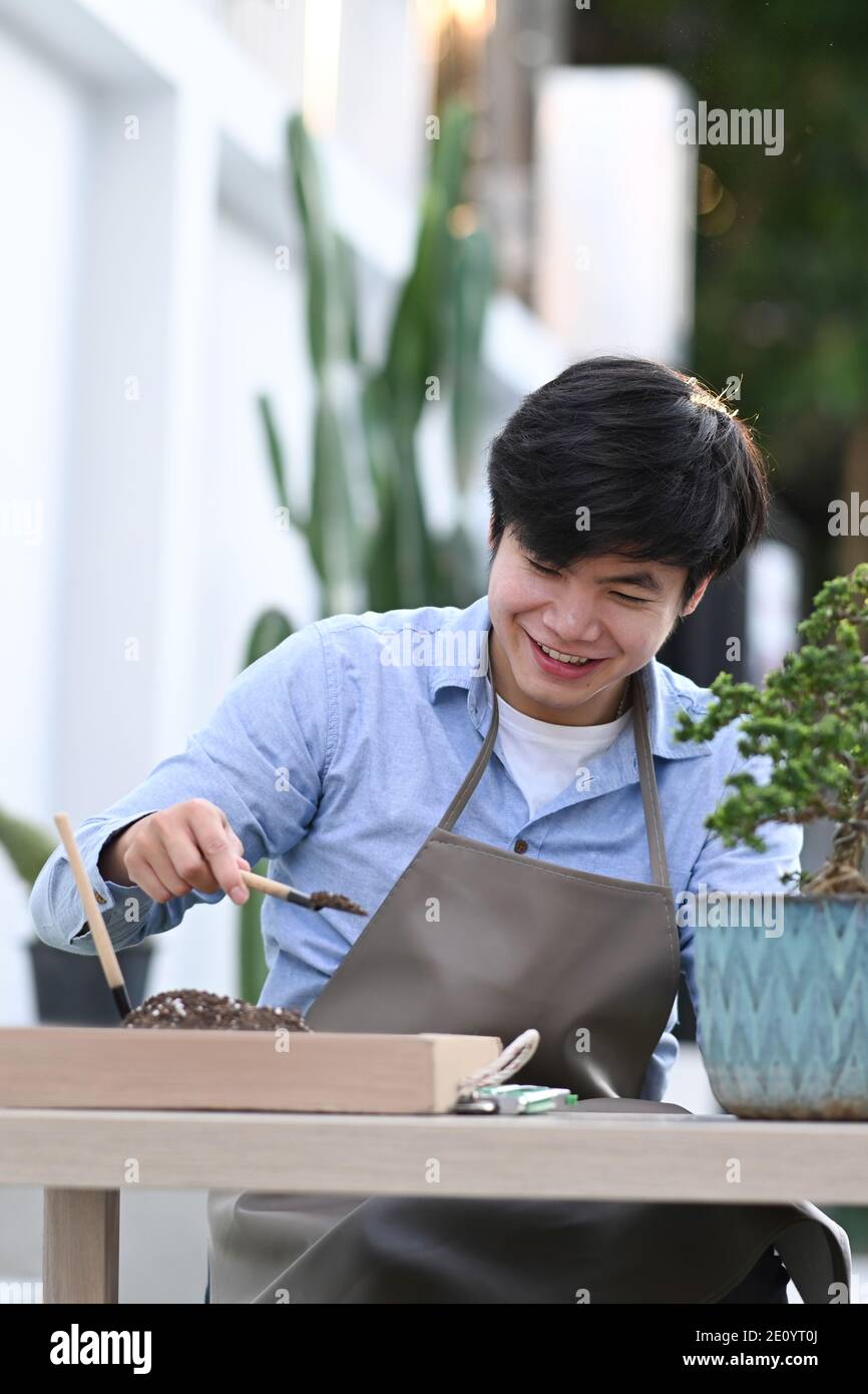 Portrait of happy gardener hand planting flowers in pot with soil Stock ...