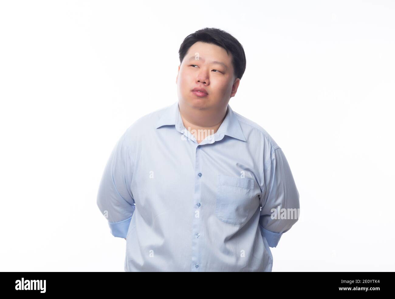 Asian fat man in blue shirt thinking and looking to copyspace isolated ...