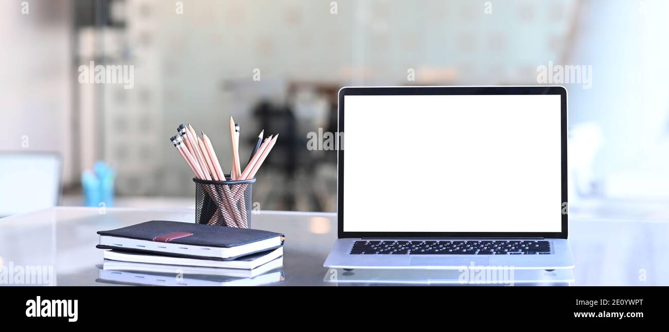 Front view of laptop computer stationery and notebook on creative ...