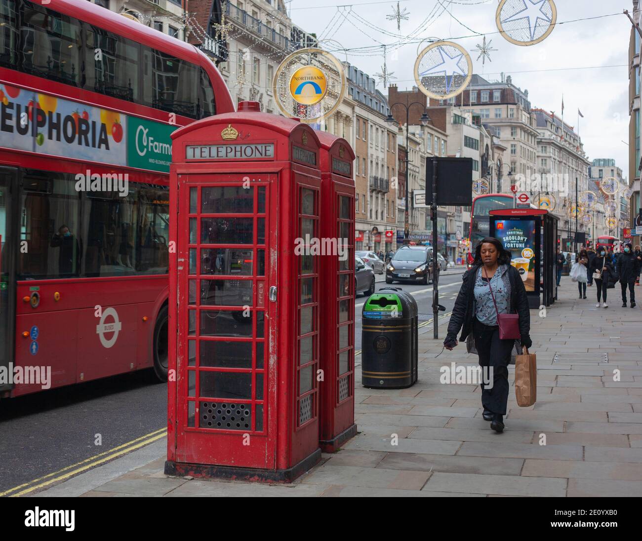 Travel Britain - View of Iconic Red Telephone Box and London Buses along the Strand, London, Britain, December 2020 Stock Photo