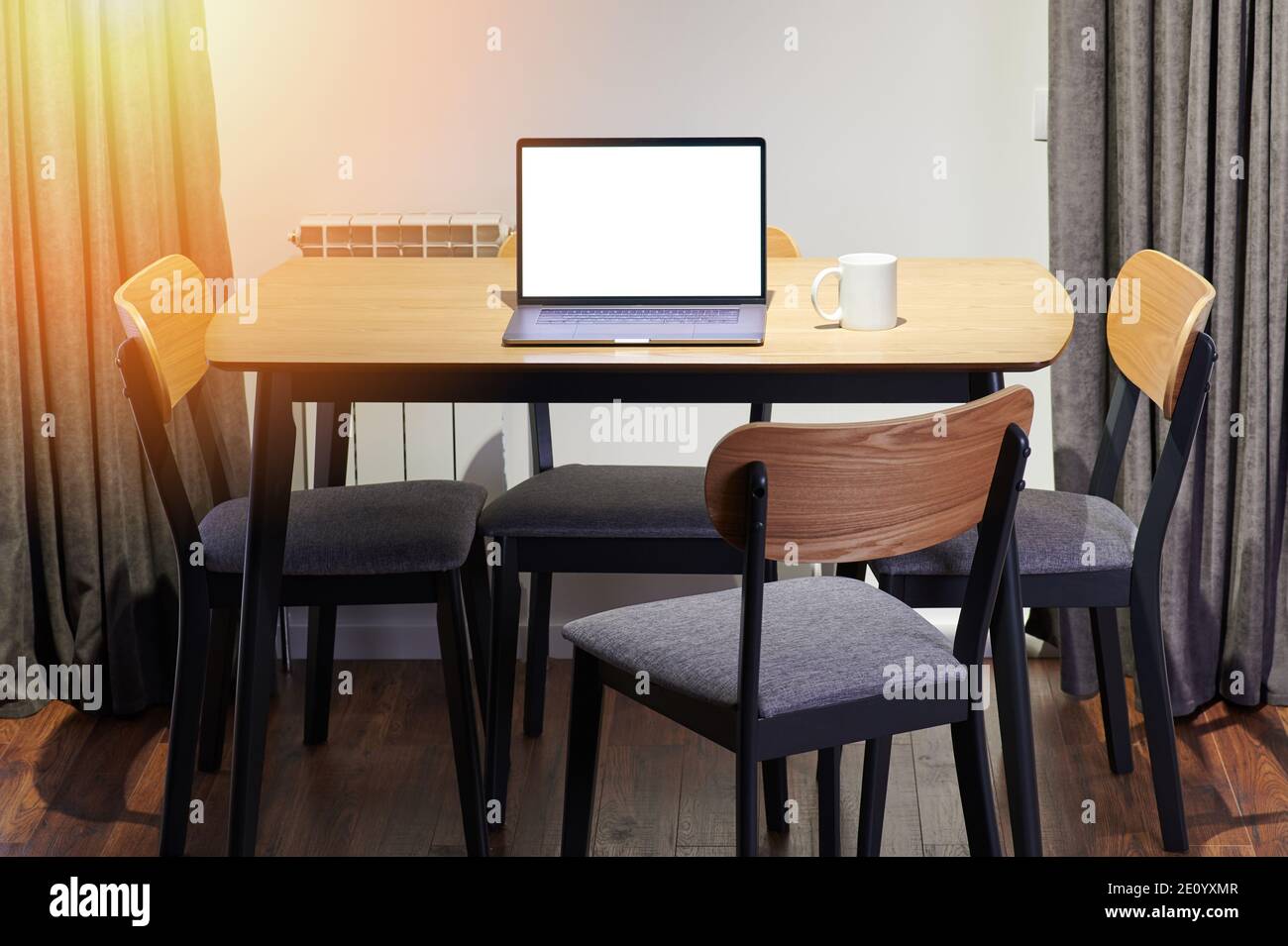 Modern interior with wooden table and laptop. Workspace in house Stock Photo