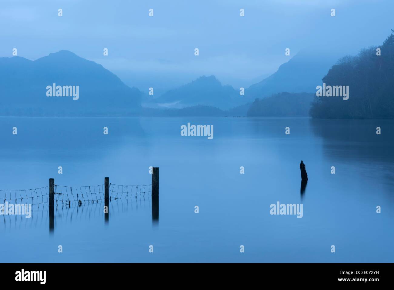 Beautiful landscape image of misty Derwentwater in Lake District on cold Winter morning Stock Photo
