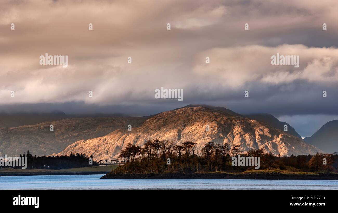 Beautiful soft light landscape image of Loch Leven in Scottish Highlands with glowing evening light on fells in distance Stock Photo