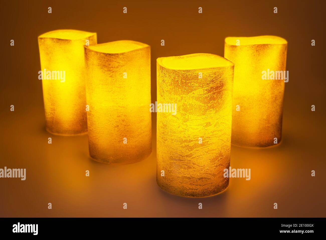 Four golden LED wax candles Stock Photo