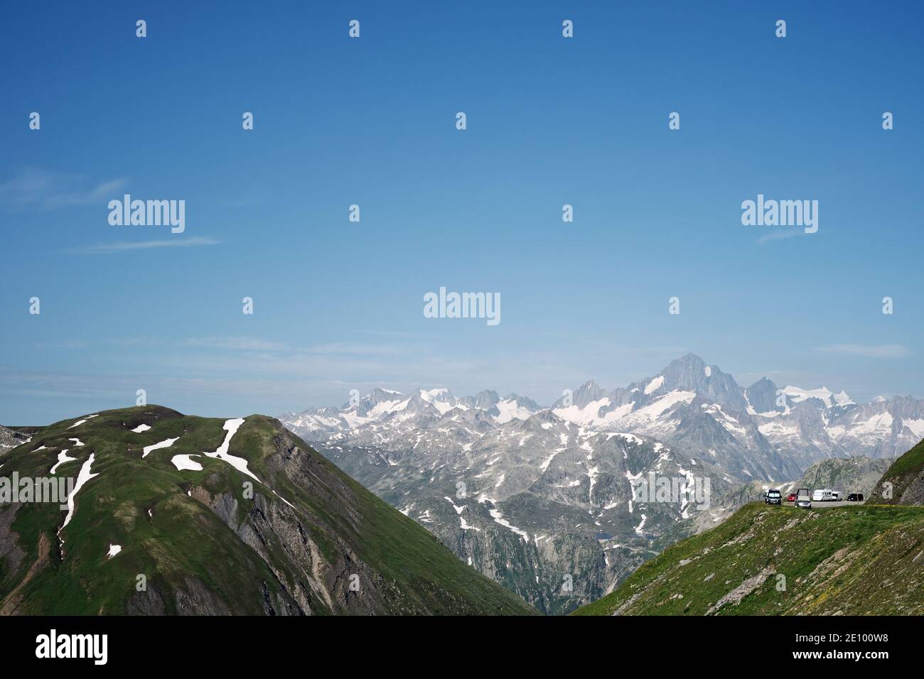 The Furka Pass mountain landscape and distant camper vans parked in the Swiss Alps mountain top landscape of Realp, Uri, Switzerland EU Stock Photo