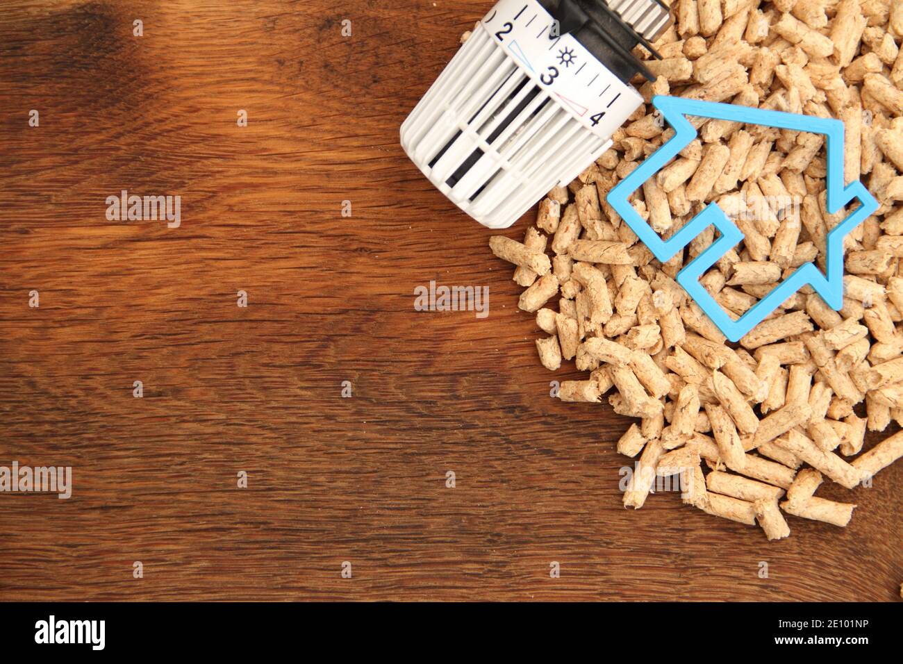 an old oak board with wood pellets and a radiator thermostat Stock Photo Alamy