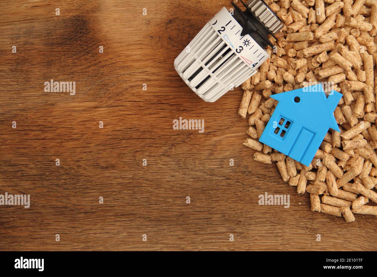 an old oak board with wood pellets and a radiator thermostat Stock Photo Alamy