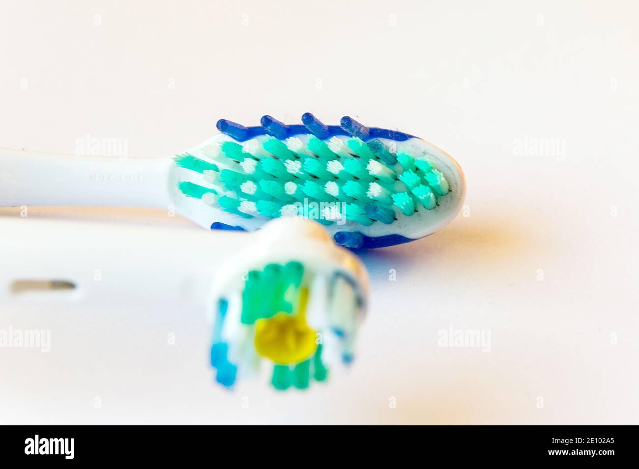 Electric and traditional toothbrushes in close-up. Toothbrush head ...