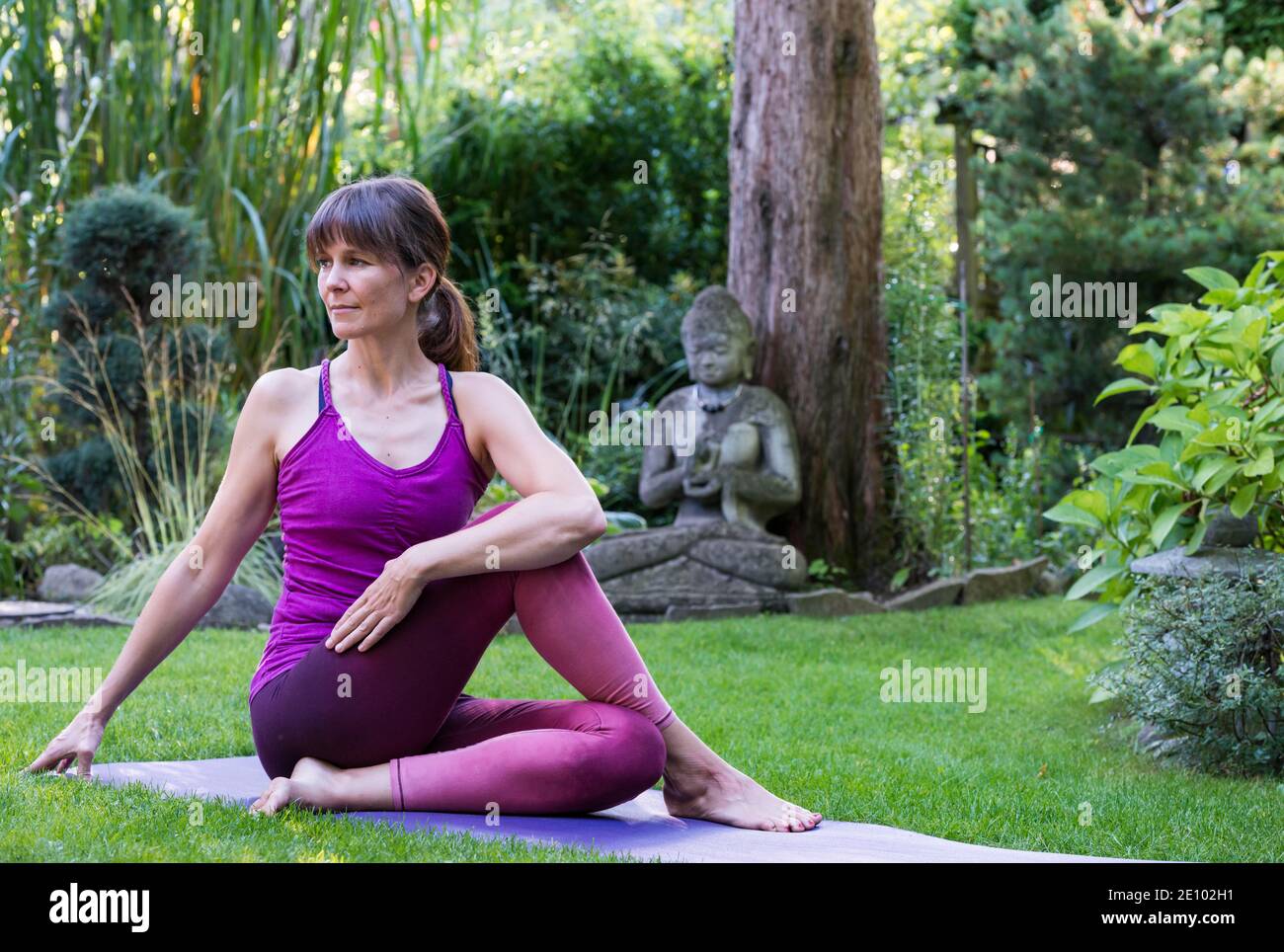 Woman doing yoga meditation watching online fitness session