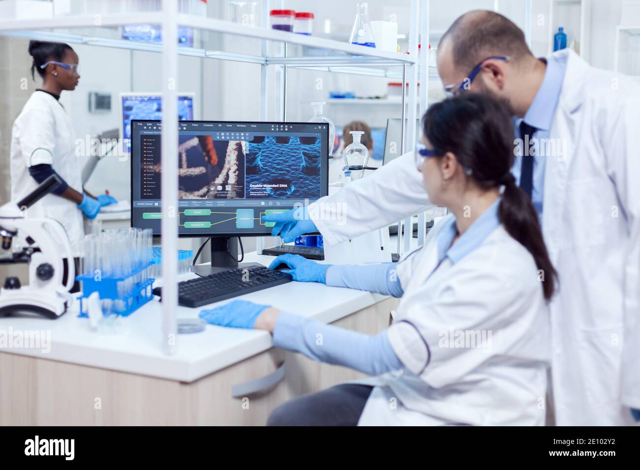 Group of scientist working with computer in laboratory. Team of ...
