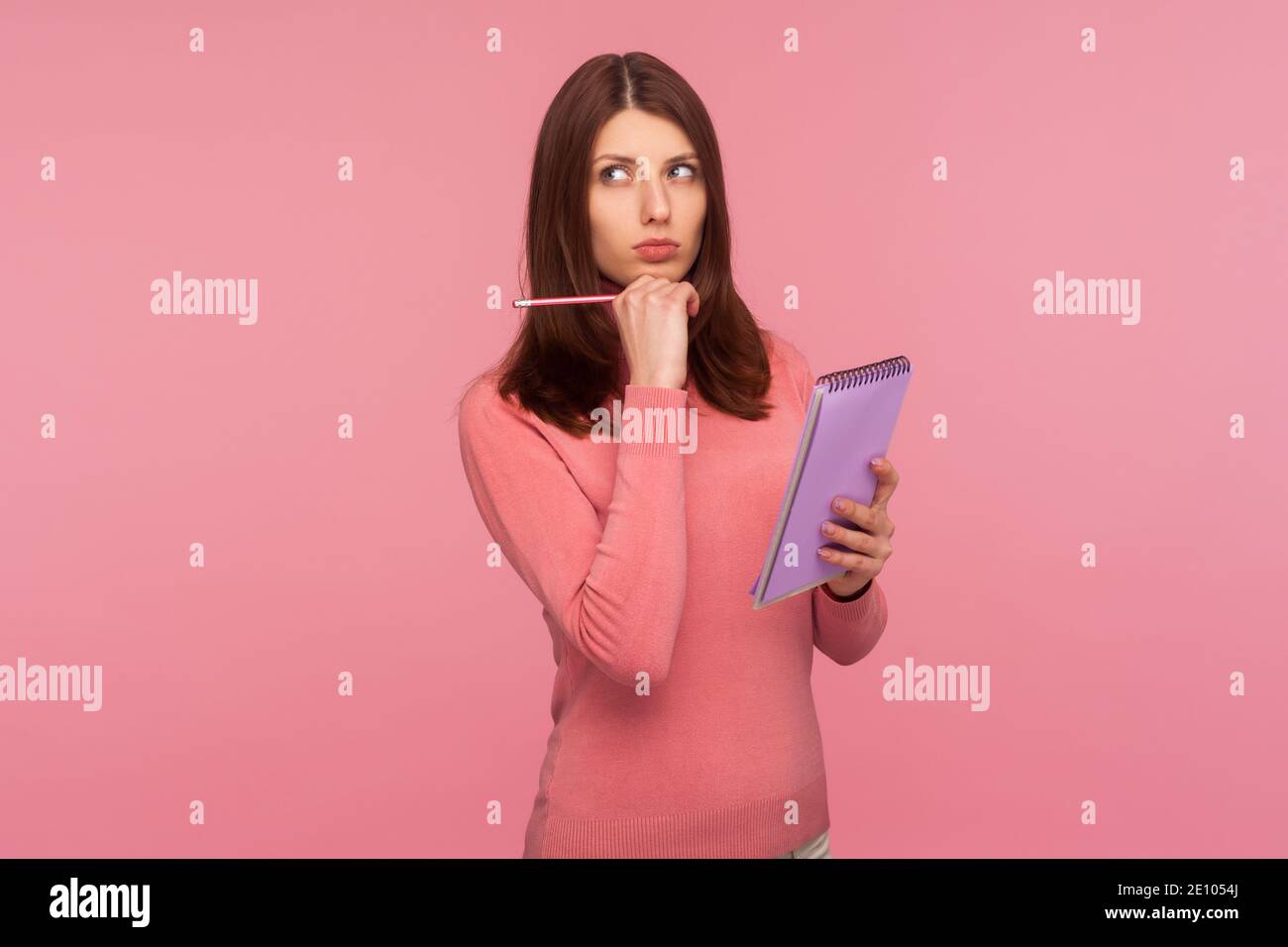 Woman thinking holding pencil hi-res stock photography and images - Alamy