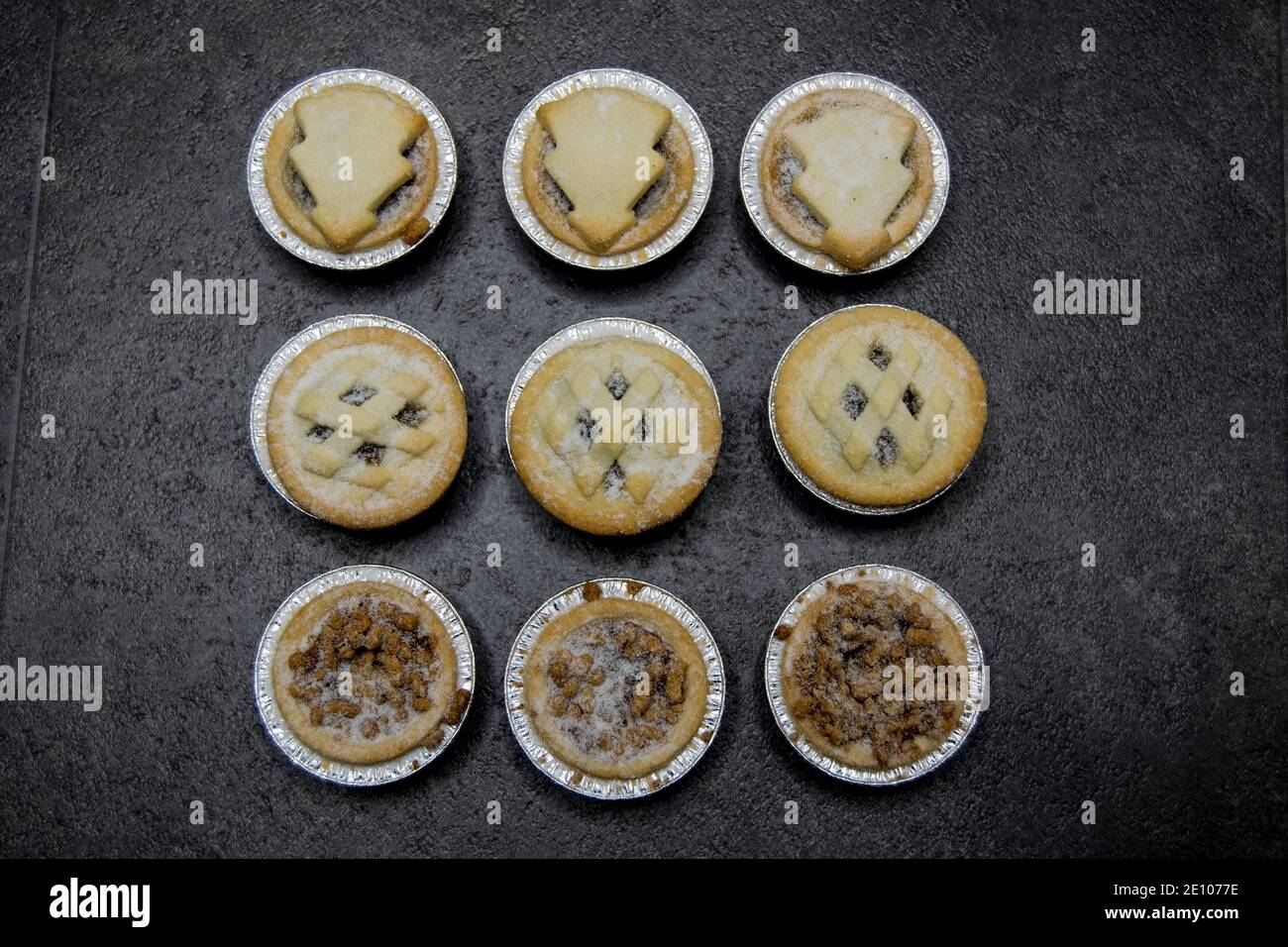 Nine Christmas mince pies on a dark background Stock Photo