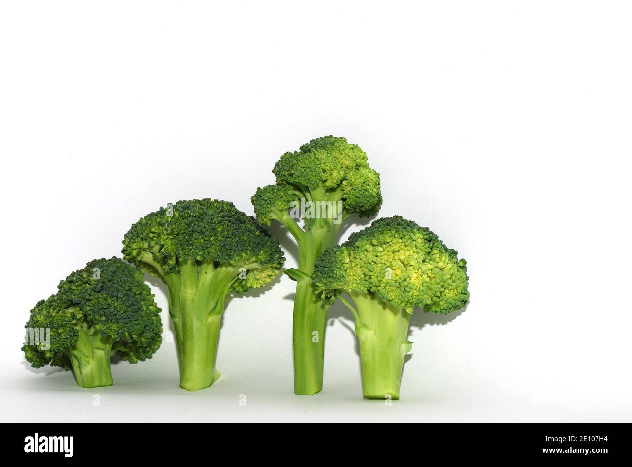 four green fresh brokoli left on white background Stock Photo