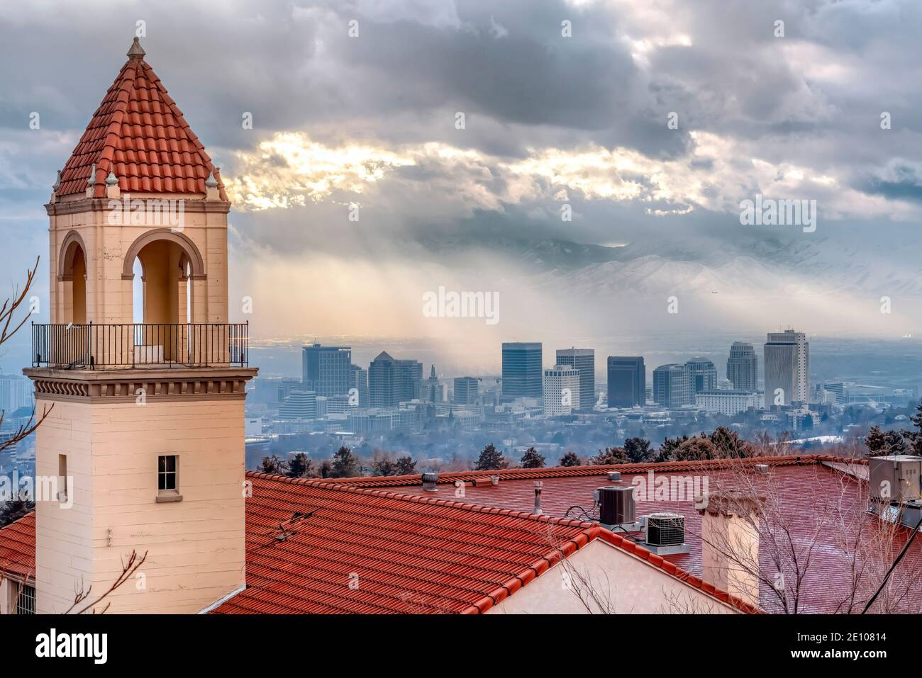 Bell tower and red rooftop of a church against foggy Salt Lake City landscape Stock Photo