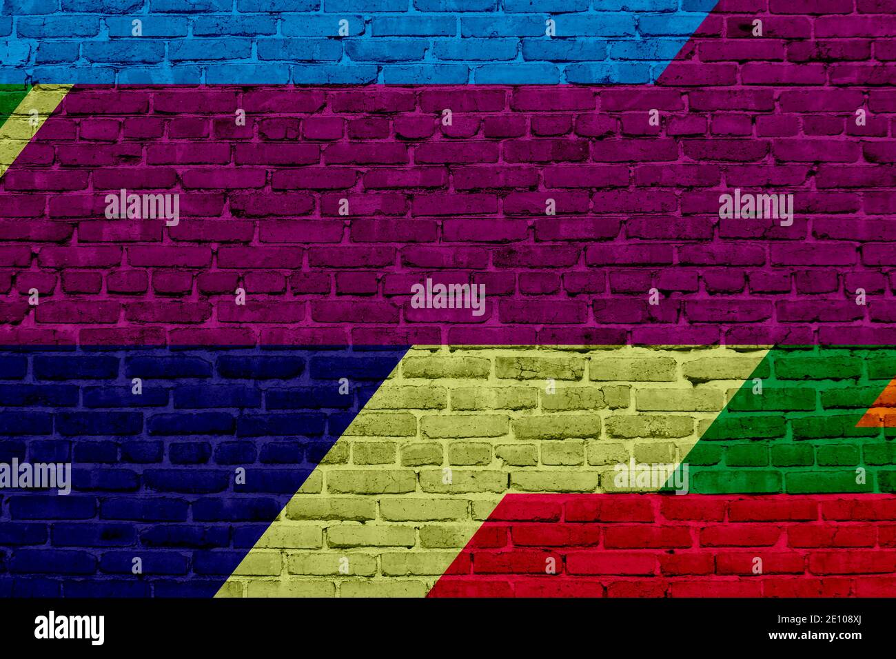 Brick wall painted with multi-colored paints. Abstract background. The old wall. Stock Photo